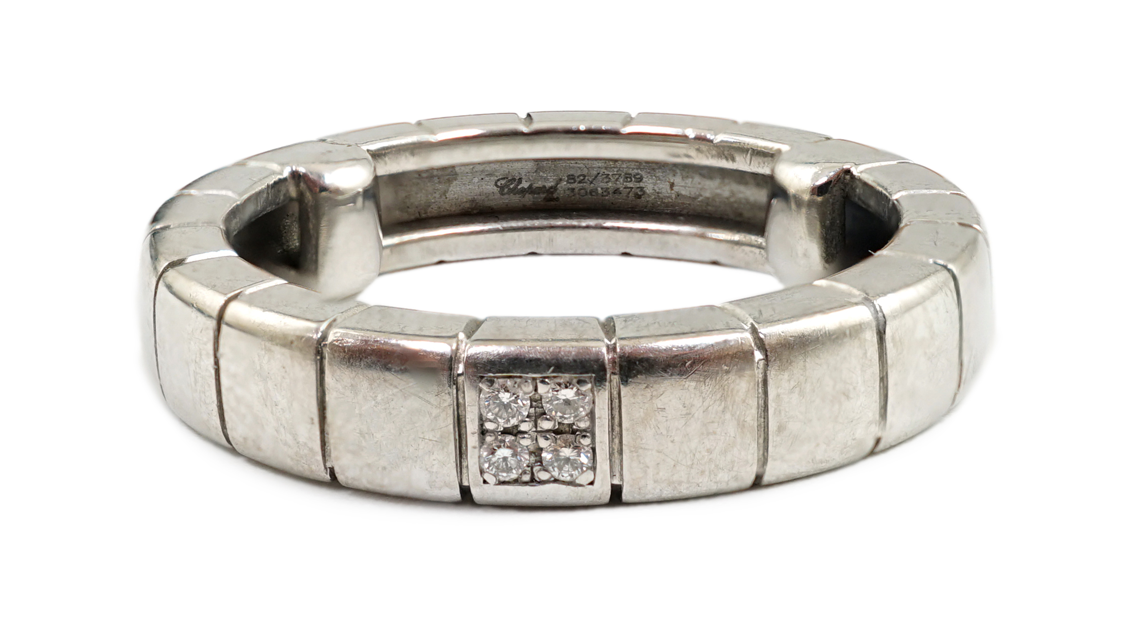 A modern Chopard 18ct white gold and four stone diamond chip cluster set band